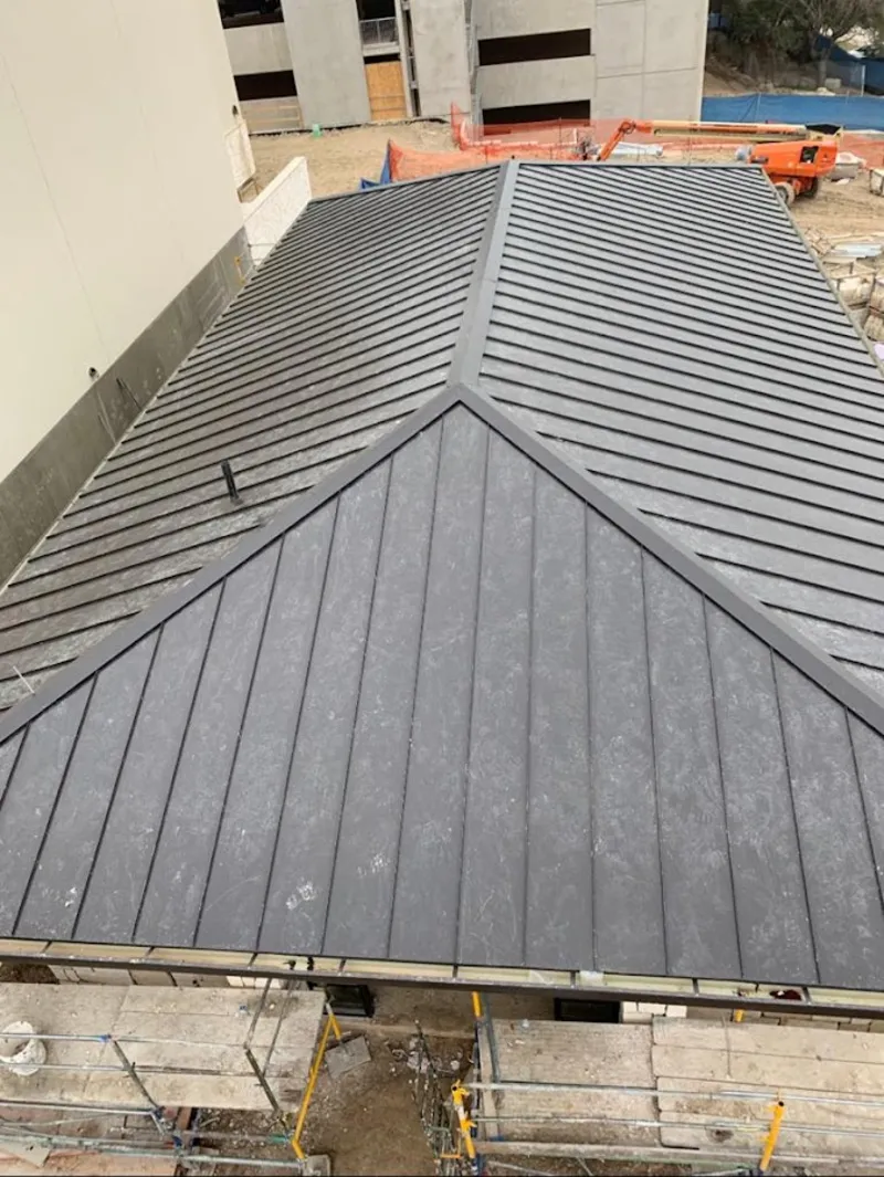 Commercial metal roof construction with crane equipment in Georgetown